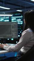 Vertical Team of programmers in data center responsible for installation and repair of networking equipment solving tasks. Teamworking colleagues doing maintenance on server room infrastructure, camera B video