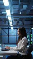 Vertical Admin in data center working with colleague to maintaining accurate documentation of equipment, generating reports. Server hub teamworking coworkers doing disaster recovery planning, camera B video