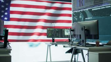 Empty military control center with a big screen shows the American flag, secret service agency protecting the country from threats. Army command room with high tech equipment. Camera B. video