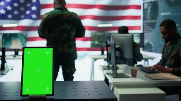 US soldiers working in a top secret operation room with copy space on screen, ensuring national safety while studying surveillance imagery from satellite cctv. Control tower. Camera B. video
