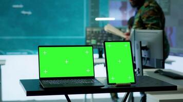 Laptop with green screen display running in military base of operations control tower, space used for gathering intelligence and support secret national defense missions. Command post. Camera A. video