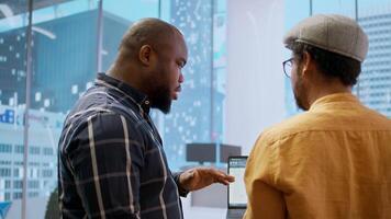 Corporate clients evaluating an investment opportunity in real estate, reviewing architectural blueprints and discussing the best strategies for office relocation and creative development. Camera A. video
