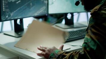 Military personnel operating in a secure office environment, processing critical information and data on big screen. Maintaining protocols essential for national defense and operations. Camera A. video