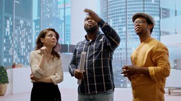 Broker and client sharing a development vision for the new office space in a high class urban building, realtor working with entrepreneur to negotiate a property leasing contract. Camera A. video