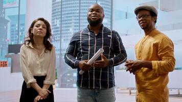 Real estate broker and client analyzing blueprints for an office space, evaluating the property and reaching a contract agreement. Businessman planning an investment strategy. Camera A. video