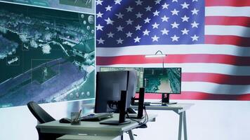 Empty operations center with an American flag working on national safety, armed forces protecting the country with anti terrorism tactics. Military control and command room headquarters. Camera A. video