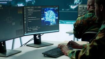 IT software engineer collecting real time data from neural network AI brain, machine learning and data mining algorithms to assist troops with defense missions. Cognitive computing. Camera A. video