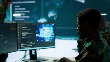 IT programming technician gathering information via neural network and artificial intelligence, employing programming language and new technology to help army operations. Deep learning. Camera A. video