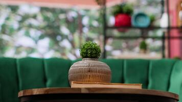 Modern empty home interior featuring green chairs and cozy wooden table, natural light. Panoramic view of the forest and contemporary design create a comfortable atmosphere in the cottage. video