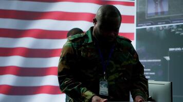 US military personnel work in a modern army command post, safeguarding classified information and state secrets against cyber attacks. Digital warfare and cybersecurity operations. Camera A. video
