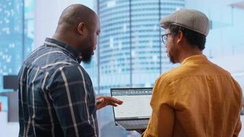 Corporate clients evaluating an investment opportunity in real estate, reviewing architectural blueprints and discussing the best strategies for office relocation and creative development. Camera B. video