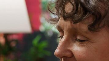 Elderly woman applying serum and lotion on her face for anti aging daily routine, trying to preserve her skin. Old person using her grooming skincare products, rejuvenating cream. Camera A. video