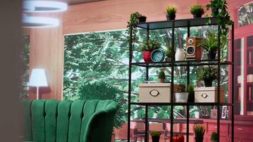 Cozy empty room with elegant green furniture and natural light with panoramic windows that offer a scenic view of the forest. Modern home decor, comfortable and stylish with an open floor plan. video