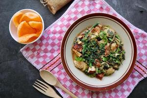 lotek is a traditional salad from Indonesia made from vegetable, chayote, kale, young jackfruit, tempeh, tofu, long beans, and bean sprouts with peanut sauce and cracker photo