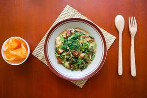 lotek is a traditional salad from Indonesia made from vegetable, chayote, kale, young jackfruit, tempeh, tofu, long beans, and bean sprouts with peanut sauce and cracker photo
