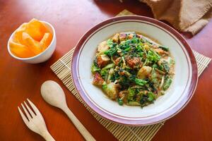 lotek is a traditional salad from Indonesia made from vegetable, chayote, kale, young jackfruit, tempeh, tofu, long beans, and bean sprouts with peanut sauce and cracker photo