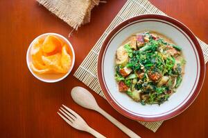 lotek is a traditional salad from Indonesia made from vegetable, chayote, kale, young jackfruit, tempeh, tofu, long beans, and bean sprouts with peanut sauce and cracker photo