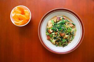 lotek is a traditional salad from Indonesia made from vegetable, chayote, kale, young jackfruit, tempeh, tofu, long beans, and bean sprouts with peanut sauce and cracker photo