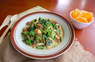 lotek is a traditional salad from Indonesia made from vegetable, chayote, kale, young jackfruit, tempeh, tofu, long beans, and bean sprouts with peanut sauce and cracker photo