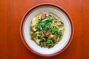 lotek is a traditional salad from Indonesia made from vegetable, chayote, kale, young jackfruit, tempeh, tofu, long beans, and bean sprouts with peanut sauce and cracker photo