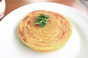 Roti Canai or Paratha Bread with Curry Sauce, Chilli Flakes and Yogurt, Top View photo
