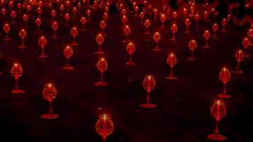 A large number of candles are lit at borobudur temple. The candles are arranged in a pattern, with some candles grouped together and others spaced apart. Scene is one of warmth and coziness photo