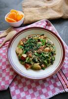 lotek is a traditional salad from Indonesia made from vegetable, chayote, kale, young jackfruit, tempeh, tofu, long beans, and bean sprouts with peanut sauce and cracker photo