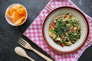 lotek is a traditional salad from Indonesia made from vegetable, chayote, kale, young jackfruit, tempeh, tofu, long beans, and bean sprouts with peanut sauce and cracker photo