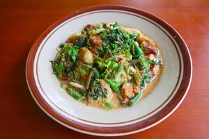 lotek is a traditional salad from Indonesia made from vegetable, chayote, kale, young jackfruit, tempeh, tofu, long beans, and bean sprouts with peanut sauce and cracker photo