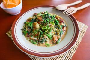 lotek is a traditional salad from Indonesia made from vegetable, chayote, kale, young jackfruit, tempeh, tofu, long beans, and bean sprouts with peanut sauce and cracker photo
