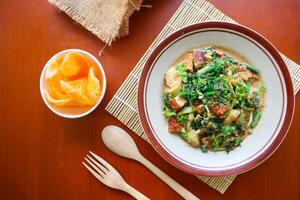 lotek is a traditional salad from Indonesia made from vegetable, chayote, kale, young jackfruit, tempeh, tofu, long beans, and bean sprouts with peanut sauce and cracker photo