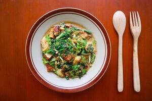 lotek is a traditional salad from Indonesia made from vegetable, chayote, kale, young jackfruit, tempeh, tofu, long beans, and bean sprouts with peanut sauce and cracker photo