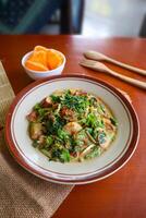 lotek is a traditional salad from Indonesia made from vegetable, chayote, kale, young jackfruit, tempeh, tofu, long beans, and bean sprouts with peanut sauce and cracker photo