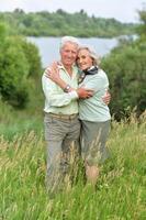 Portrait of senior couple resting in the park photo