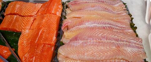 arrangement of pieces of salmon and tuna in the supermarket photo