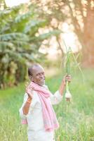 Indian farmer holding onion plant photo
