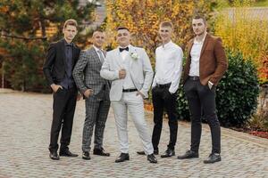 A group of men are dressed in suits and ties, posing for a photo. Scene is formal and professional photo