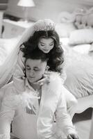 A man and woman are posing for a picture, with the woman wearing a crown. The man is sitting on the woman's shoulders photo