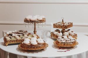 A table with a variety of desserts, including cupcakes and donuts. The table is set for a special occasion, and the desserts are arranged in a way that is visually appealing and inviting photo