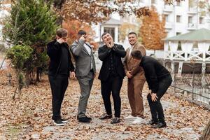 A group of men are posing for a picture in a park photo