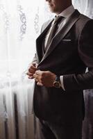 A man in a suit is getting ready to go out photo
