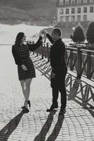 A man and woman are dancing on a sidewalk photo