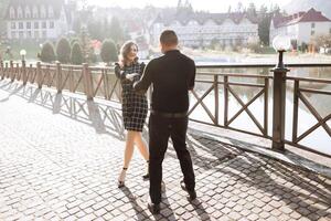A man and a woman are dancing on a brick walkway photo