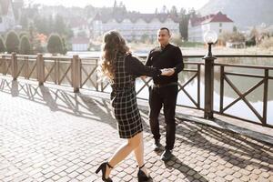 A man and woman are dancing on a brick walkway photo