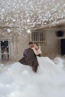 A bride and groom are dancing in the air with confetti falling around them photo