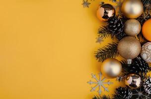 Pine Branches and Ornaments on Yellow Background photo