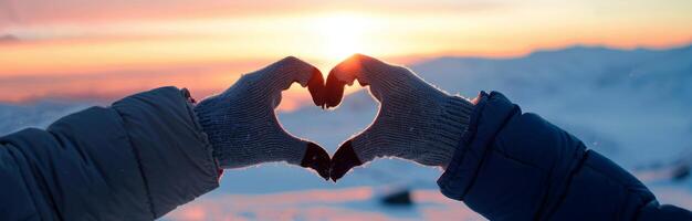 Hands Forming Heart Shape at Sunset photo