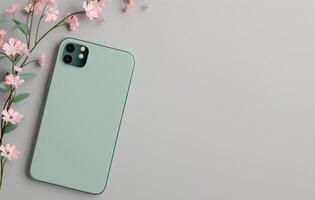 Green Smartphone on White Table With Pink Flowers photo
