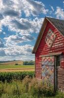 Red Barn With Quilt Design in Rural Landscape photo