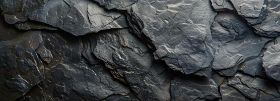 Close Up Of A Cracked And Rough Dark Grey Rock Surface photo